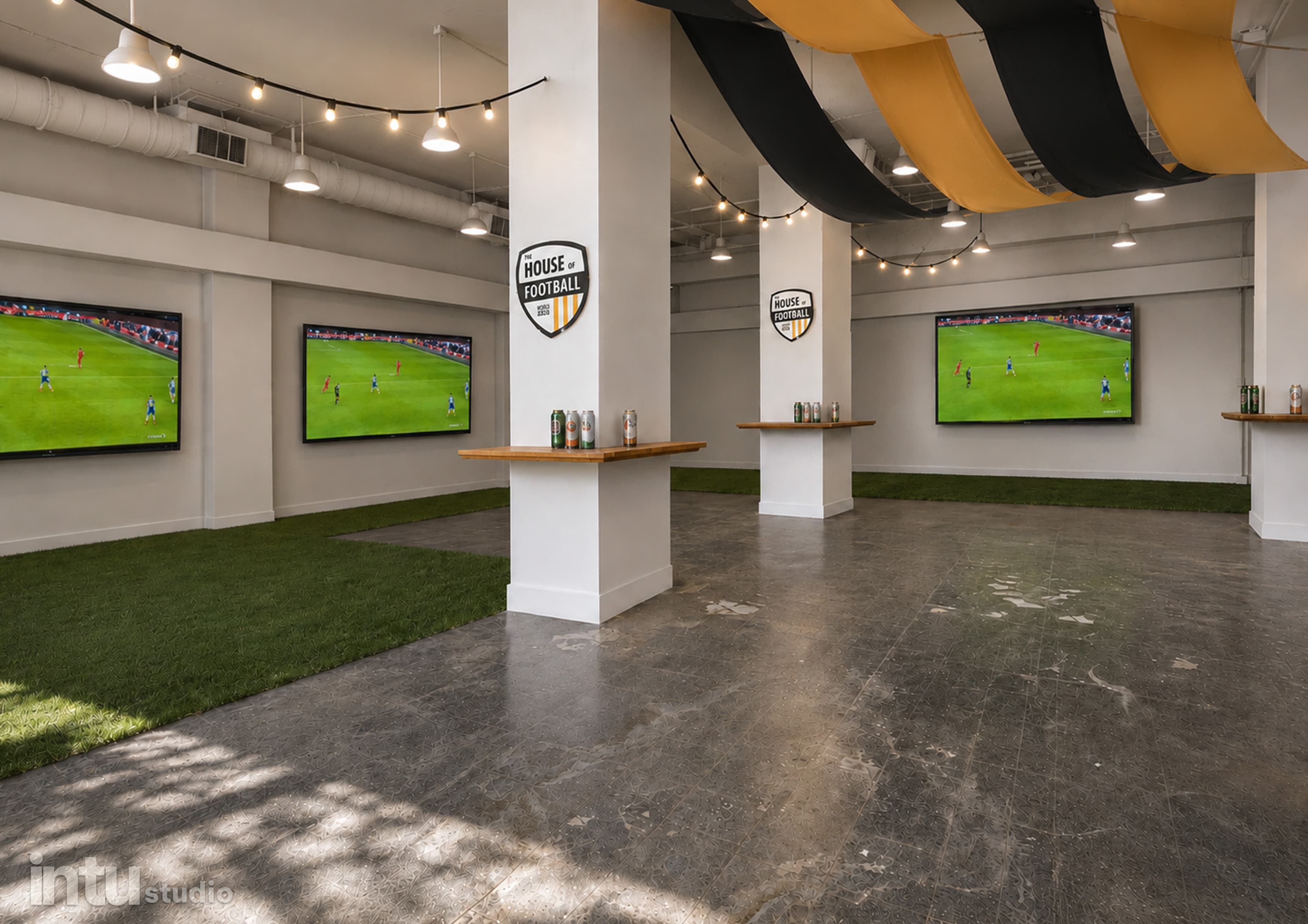 Main viewing area with large screens, string lights, and black-and-gold draped ceiling